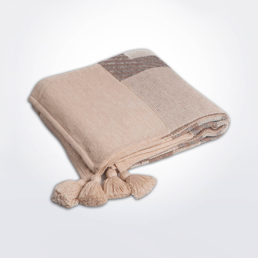 Beige ethnic alpaca throw gray background.