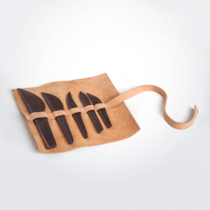 Wooden cutlery set with leather pack grey background.