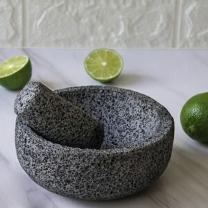 Volcanic stone mortar and pestle with limes.